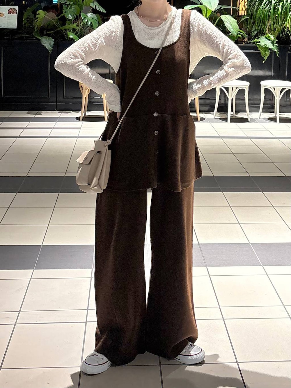 ブラウン系のつなぎ/オールインワン、ゴールド系のチョーカー、ベージュ系のイヤリングを着用したレディースの冬コーディネートの2枚目の写真