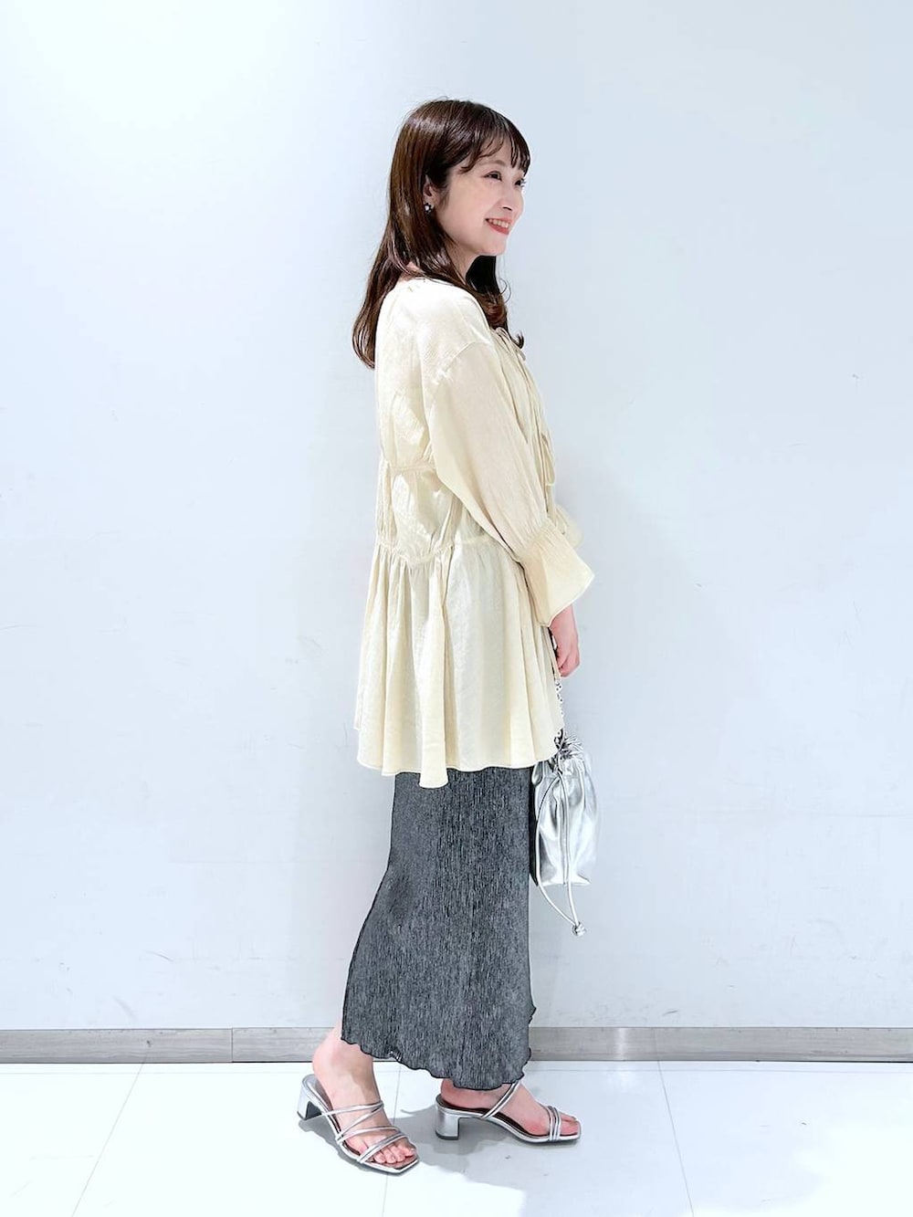 ホワイト系のTシャツ/カットソー、シルバー系のサンダル、シルバー系のショルダーバッグを着用したレディースの春コーディネートの4枚目の写真