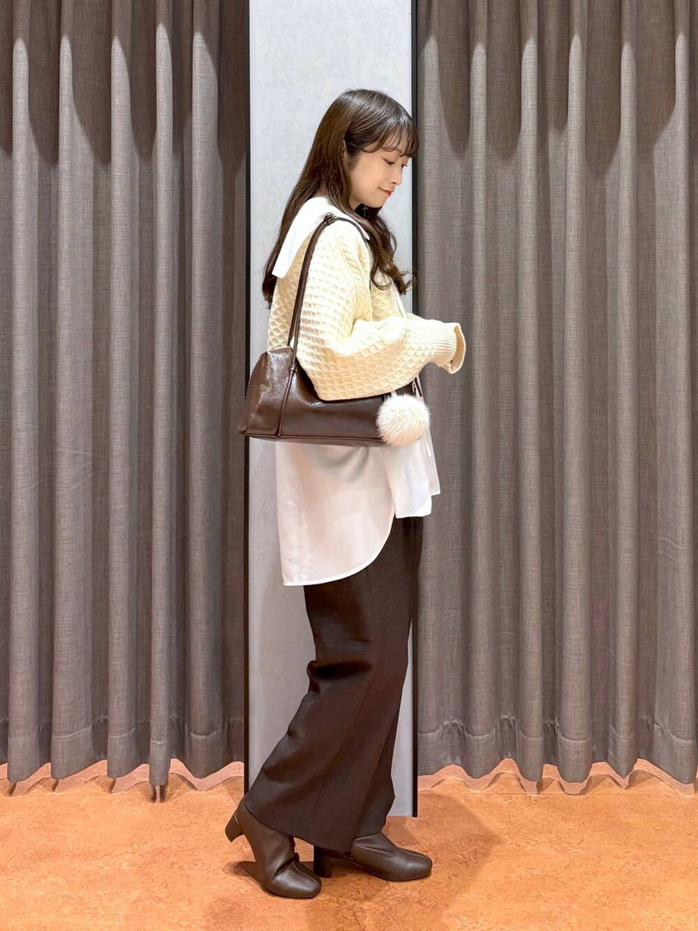 ブラウン系のその他パンツ、ブラウン系のボストンバッグ、ホワイト系のシャツ/ブラウスを着用したレディースの秋コーディネートの3枚目の写真