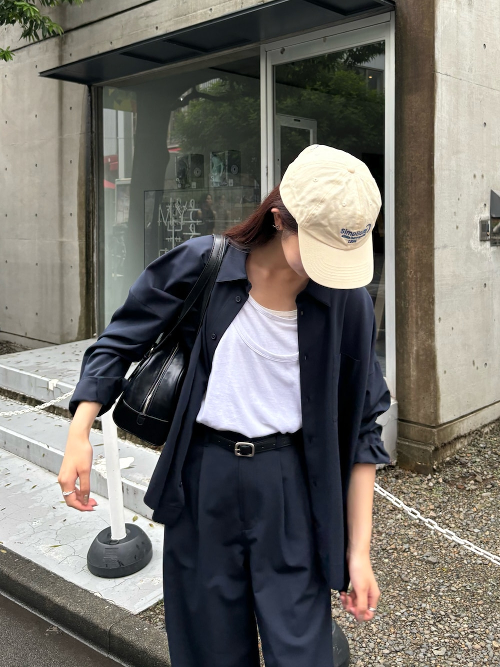 ホワイト系のタンクトップ、ブラック系のボストンバッグ、ブルー系のシャツ/ブラウスを着用したレディースの秋コーディネートの2枚目の写真