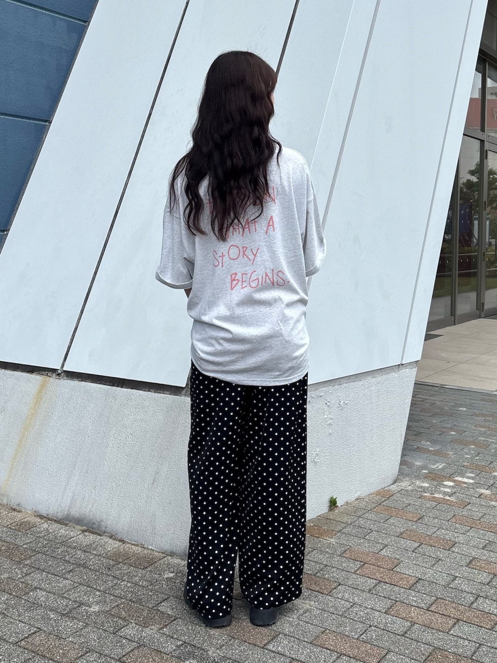 グレー系のTシャツ/カットソー、ピンク系のカーディガン/ボレロ、ブラック系のボストンバッグを着用したレディースの春コーディネートの2枚目の写真