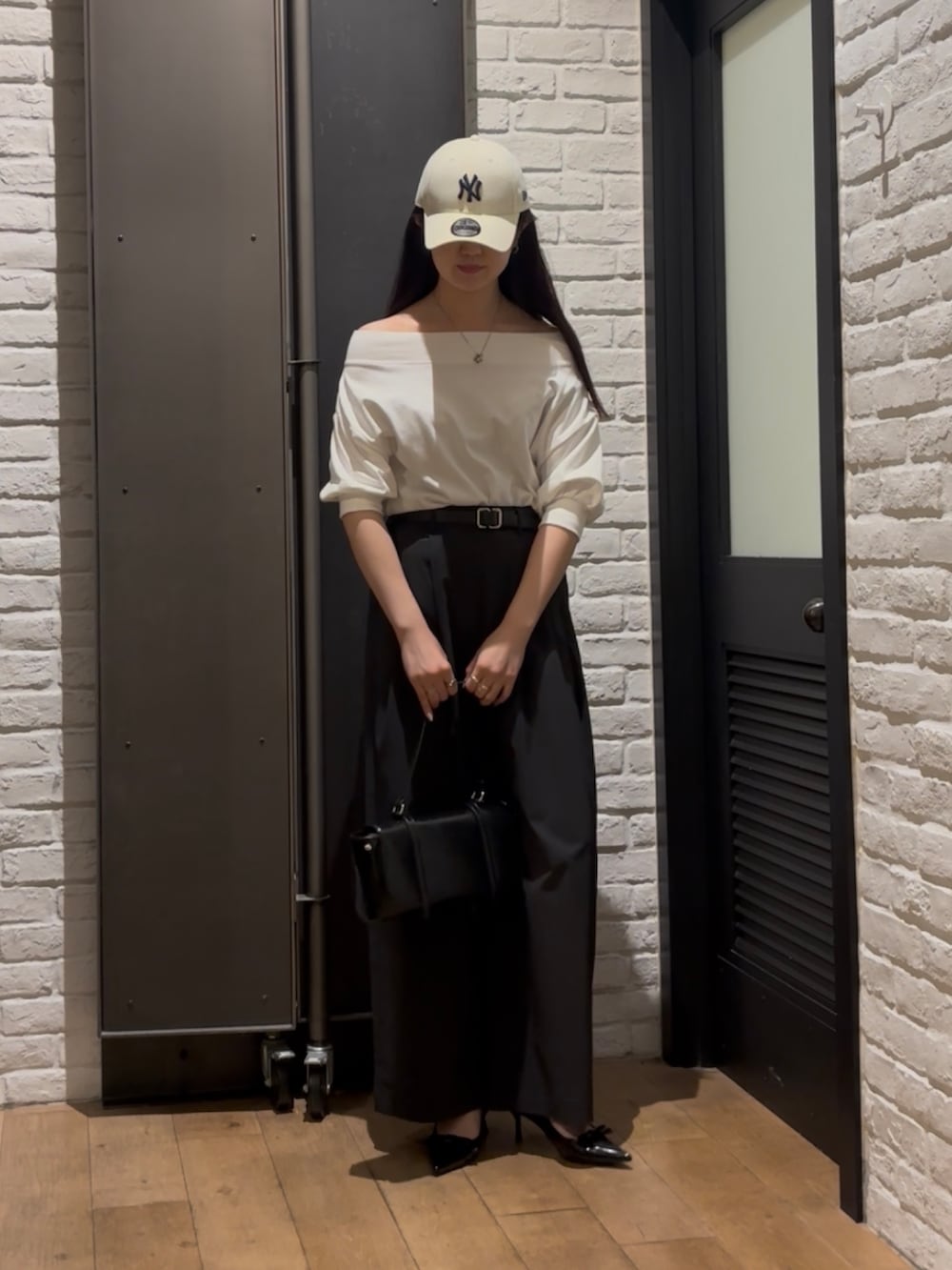 ホワイト系のスウェット、ブラック系のその他パンツ、ブラック系のハンドバッグを着用したレディースの夏コーディネートの5枚目の写真