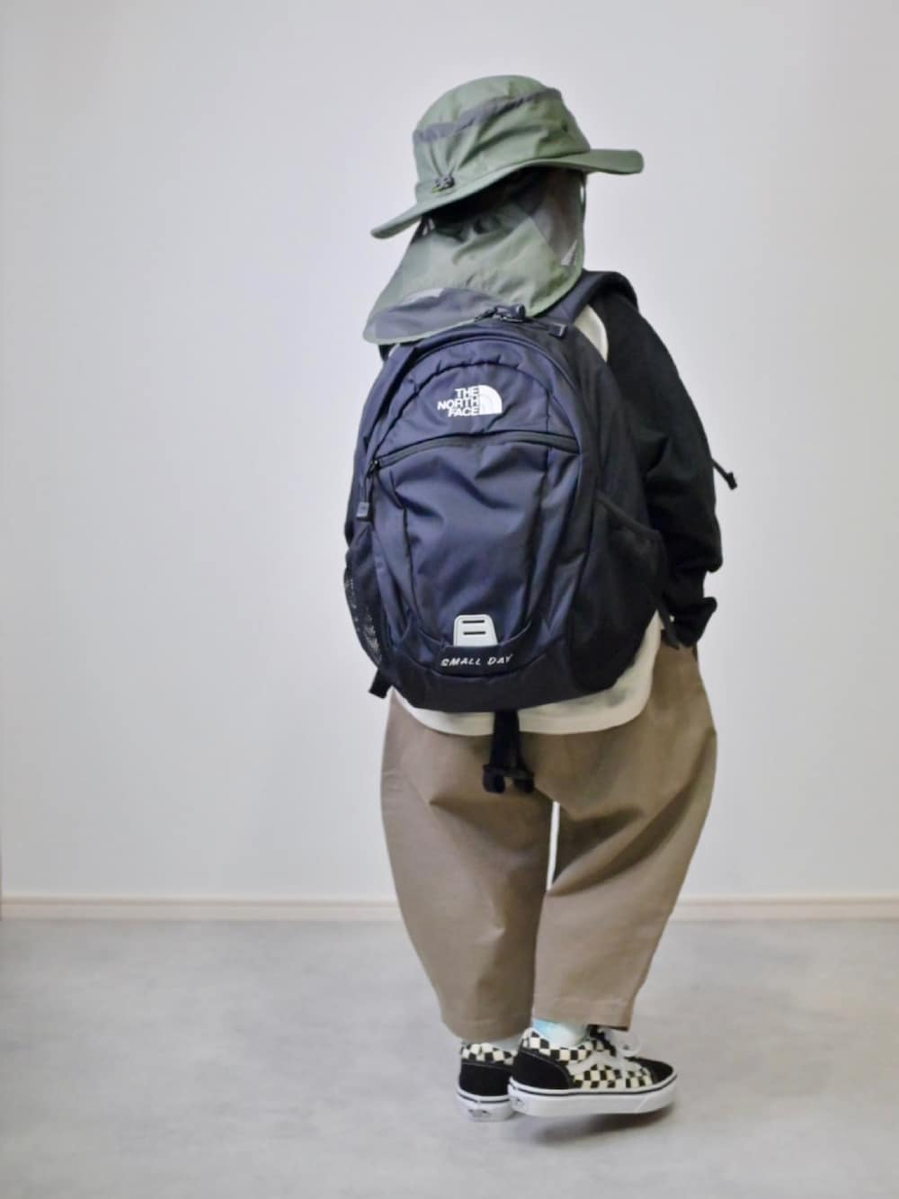 ブラック系のTシャツ/カットソー、ブラウン系のチノパンツ、ブラック系のスニーカーを着用したキッズの秋コーディネートの2枚目の写真