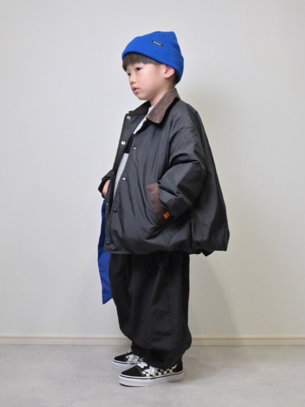 ブラック系のブルゾン、グレー系のスウェット、ブラック系のその他パンツを着用したキッズの秋コーディネートの3枚目の写真