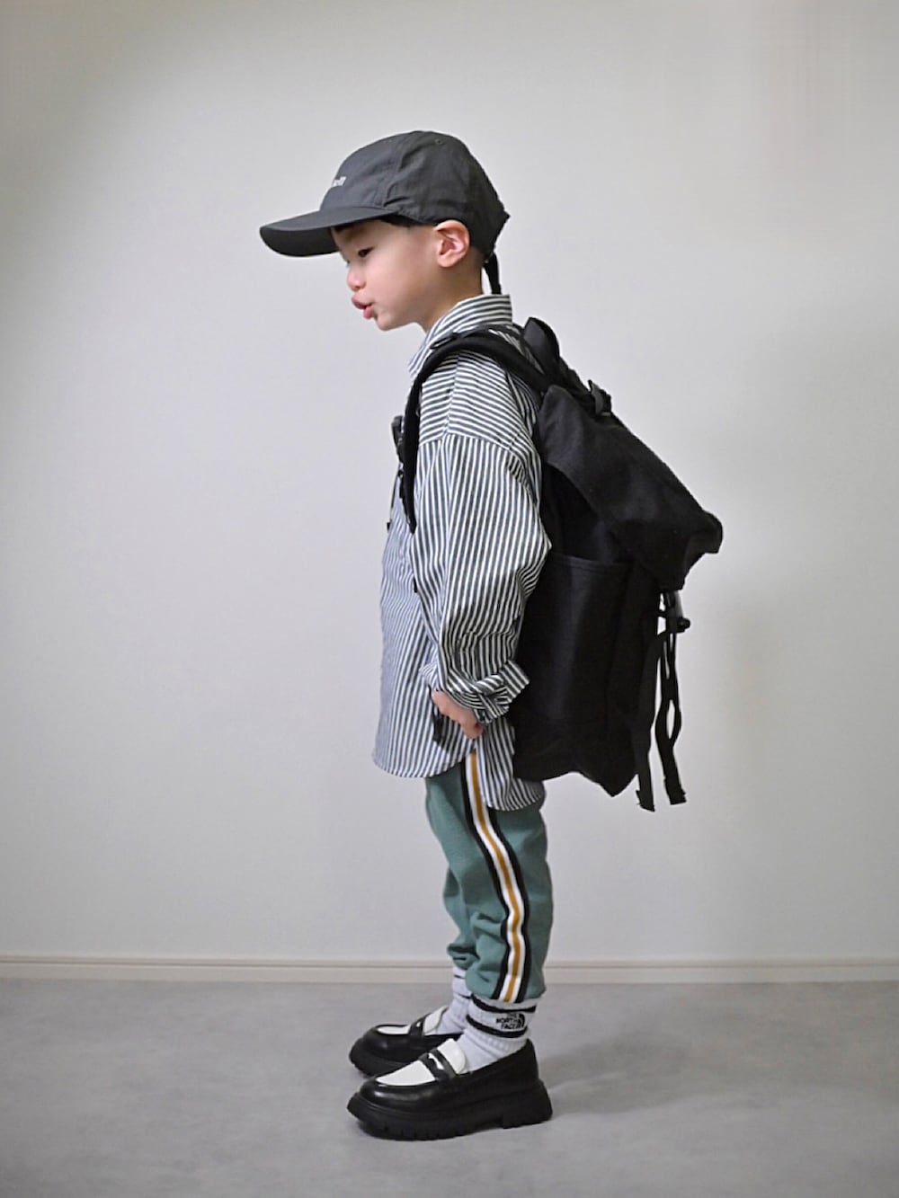 グレー系のブルゾン、グリーン系のその他パンツ、ブラック系のシャツ/ブラウスを着用したキッズの冬コーディネートの3枚目の写真