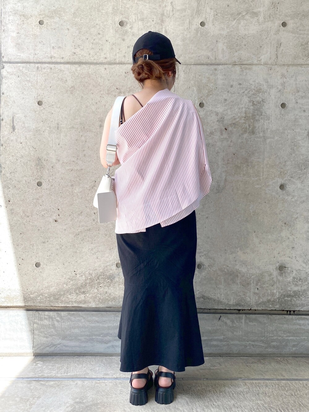 ブラック系のワンピース、ブラック系のサンダル、ホワイト系のショルダーバッグを着用したレディースの夏コーディネートの4枚目の写真