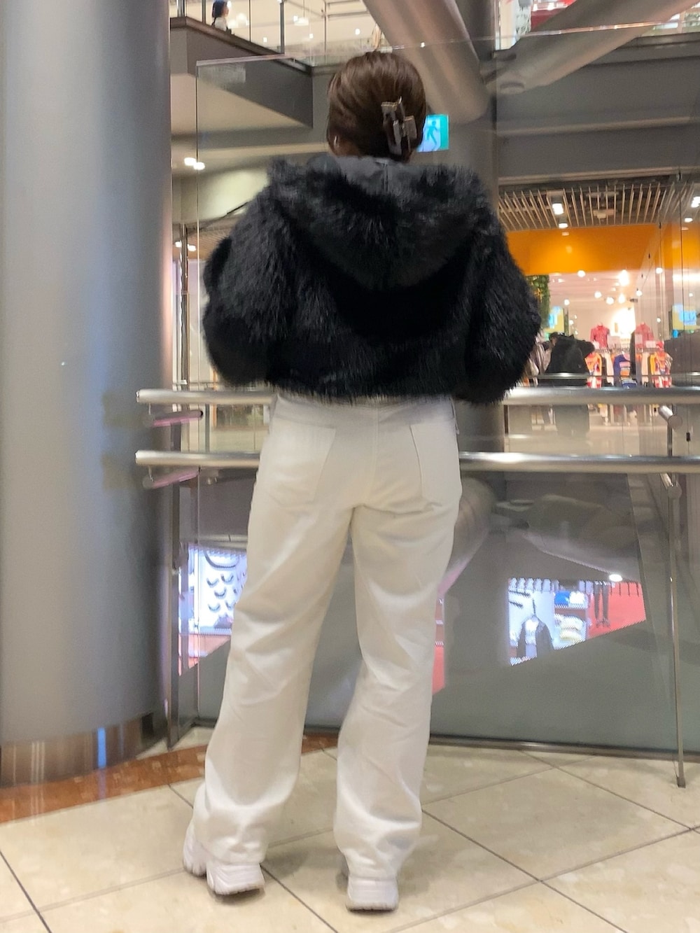 ブラック系のブルゾン、グレー系のTシャツ/カットソー、ホワイト系のデニムパンツを着用したレディースの秋コーディネートの4枚目の写真