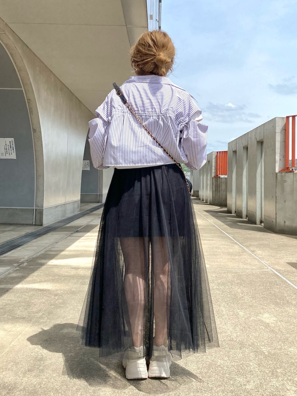 ホワイト系のTシャツ/カットソー、ブラック系のシャツ/ブラウス、ブラック系のスカートを着用したレディースの春コーディネートの4枚目の写真