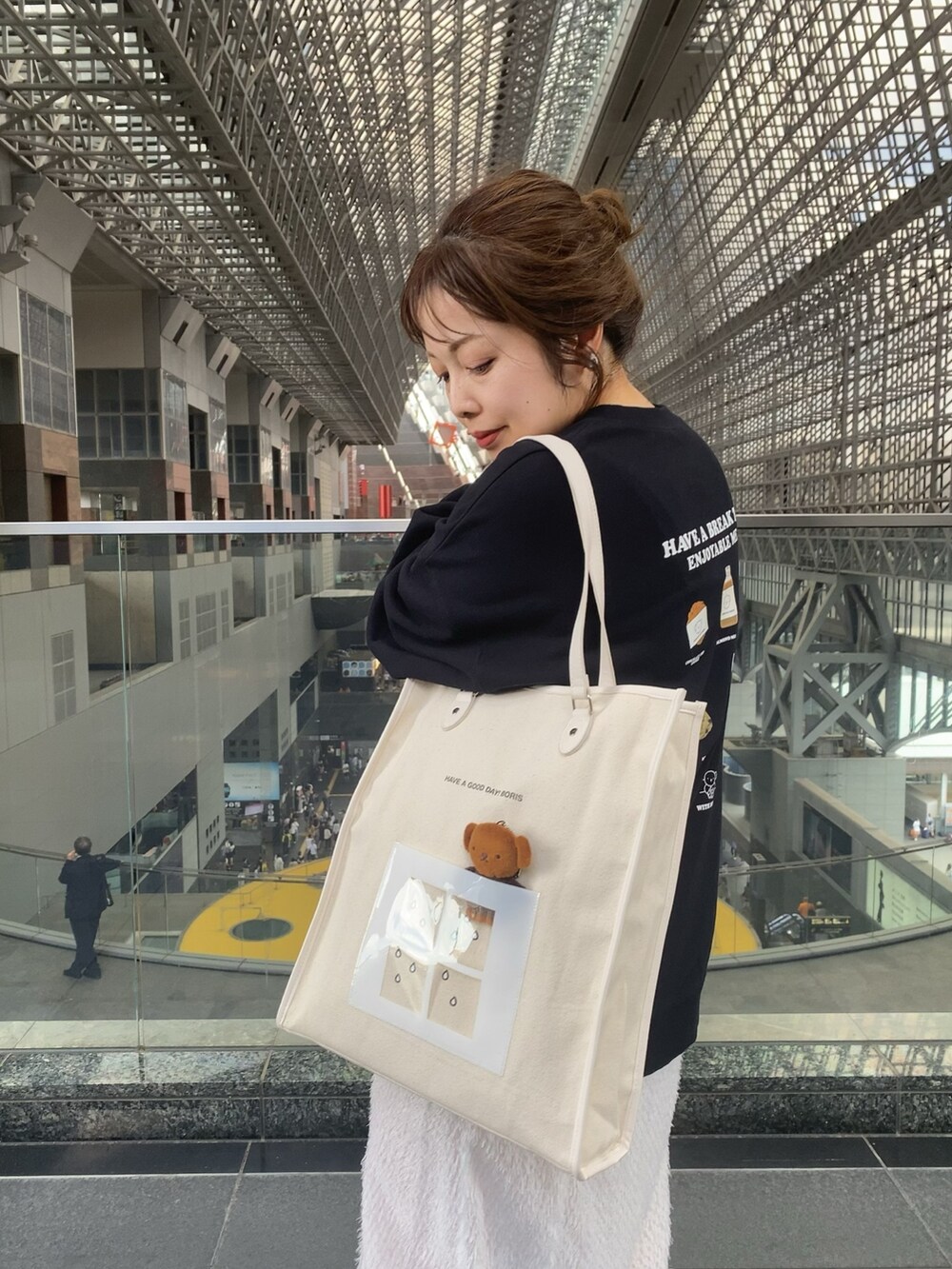 ブラック系のスウェット、ブラウン系のトートバッグを着用したレディースの夏コーディネートの2枚目の写真