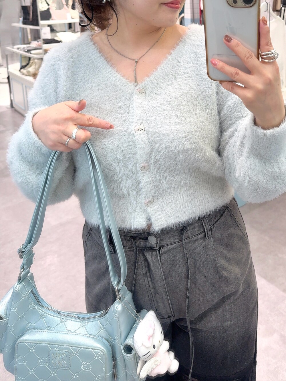 ブルー系のカーディガン/ボレロ、ブラック系のデニムパンツ、ブルー系のショルダーバッグを着用したレディースの秋コーディネートの3枚目の写真