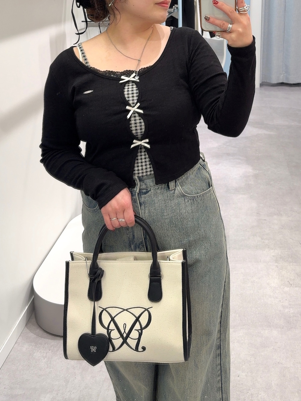 ブラック系のTシャツ/カットソー、ブルー系のその他パンツ、ホワイト系のトートバッグを着用したレディースの冬コーディネートの2枚目の写真