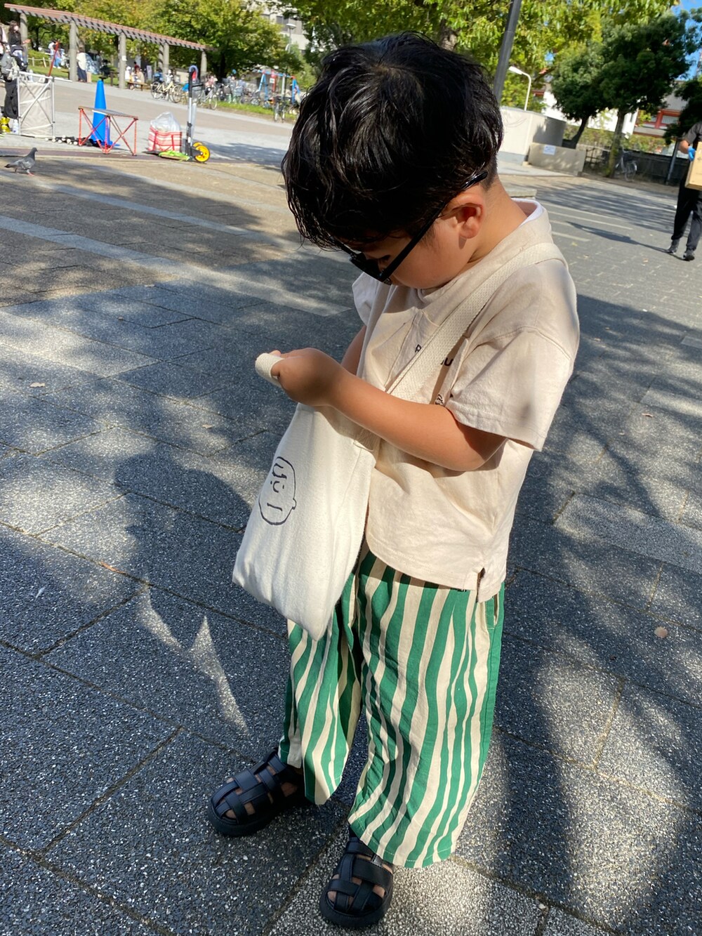 ブラック系のサンダル、グリーン系のその他パンツを着用したキッズの秋コーディネートの2枚目の写真