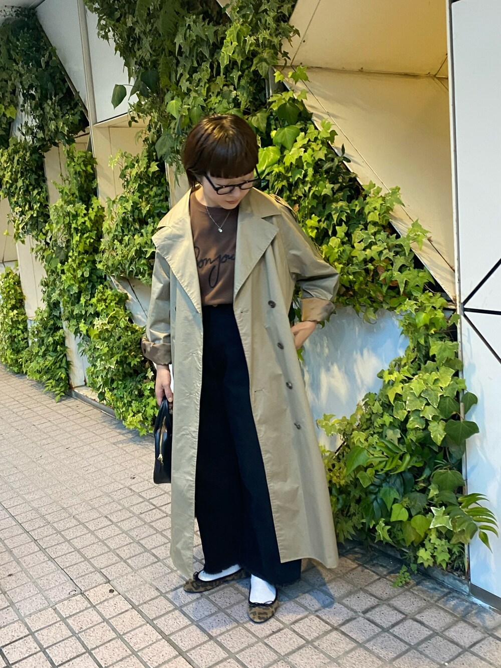 ブラウン系のTシャツ/カットソー、ベージュ系のトレンチコート、その他のバレエシューズを着用したレディースの夏コーディネートの3枚目の写真