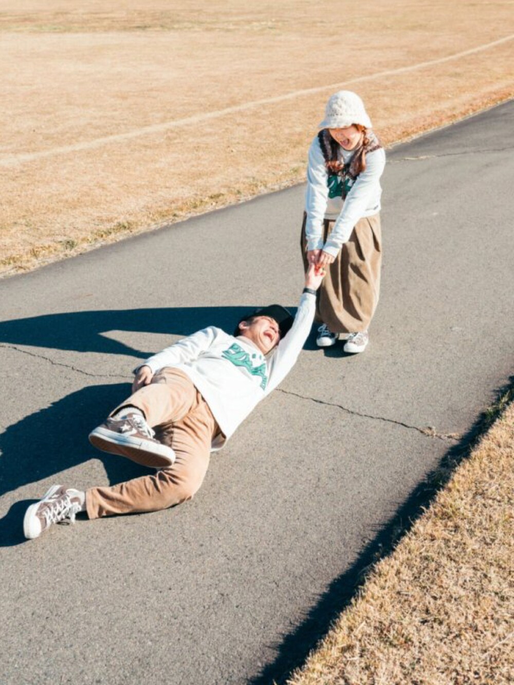 ベージュ系のスカート、ブラウン系のスニーカー、グレー系のスウェットを着用したレディースの冬コーディネートの4枚目の写真