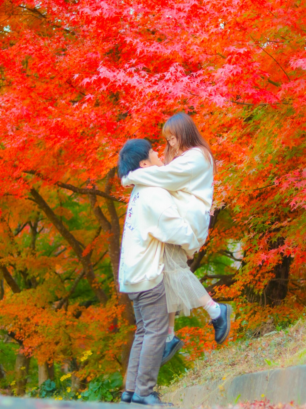 グレー系のパンツ、ブラック系のドレスシューズ、ホワイト系のスカートを着用したレディースの秋コーディネートの3枚目の写真