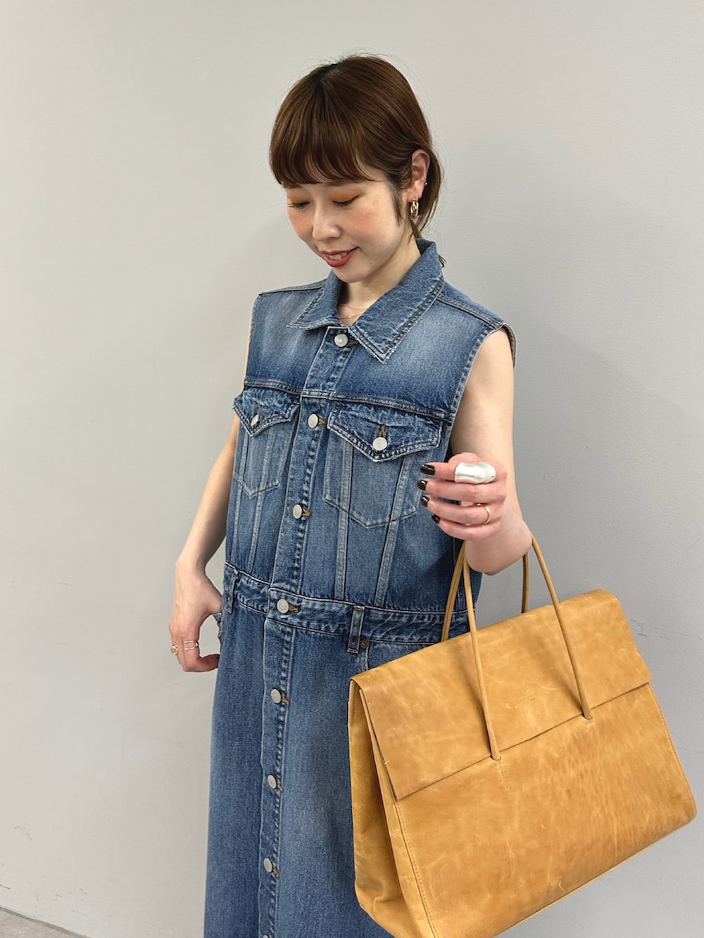 ブルー系のワンピース、イエロー系のボストンバッグを着用したレディースの春コーディネートの6枚目の写真