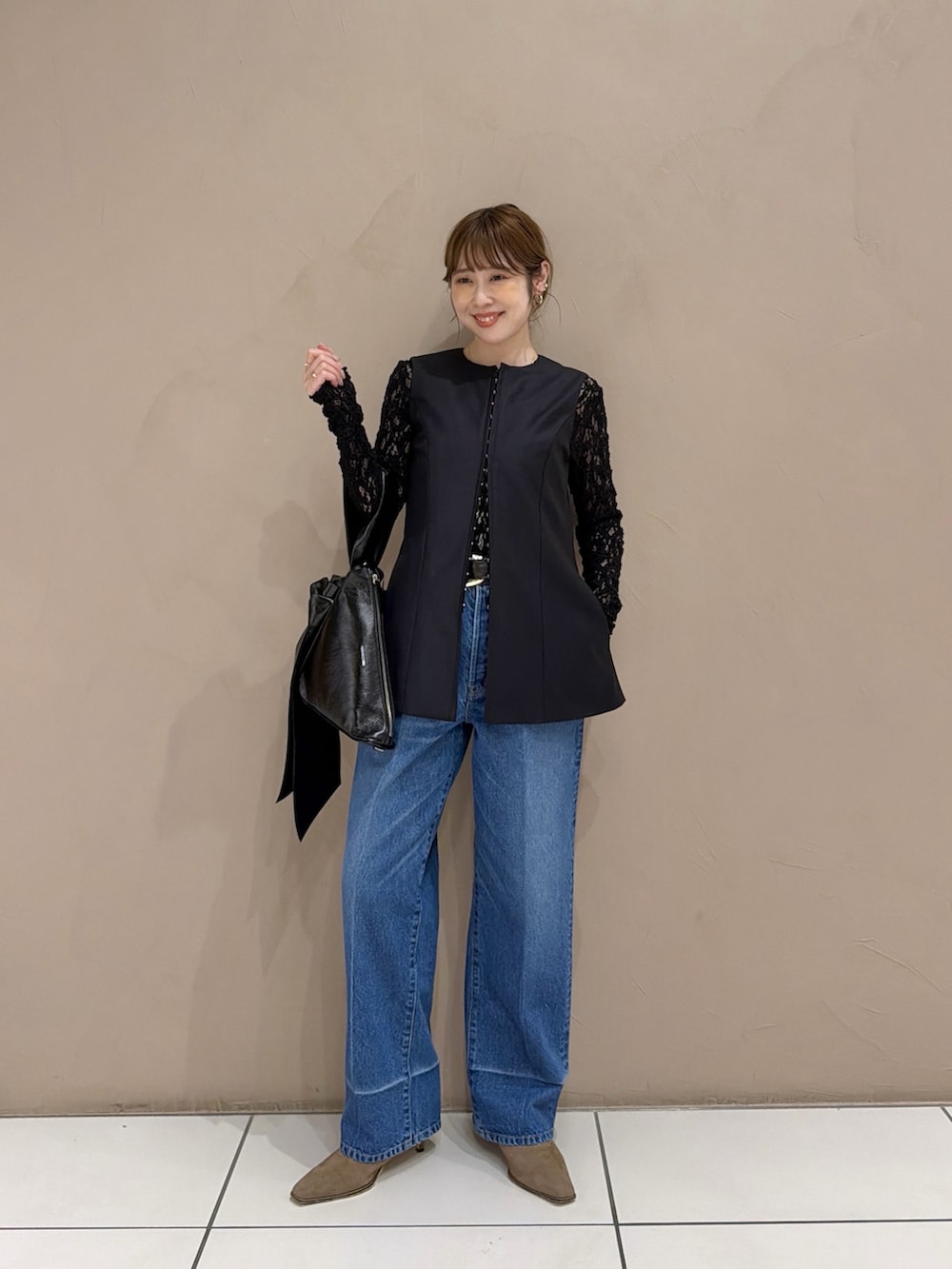 ブラック系のTシャツ/カットソー、グレー系のベスト、ブルー系のベストを着用したレディースの秋コーディネートの2枚目の写真