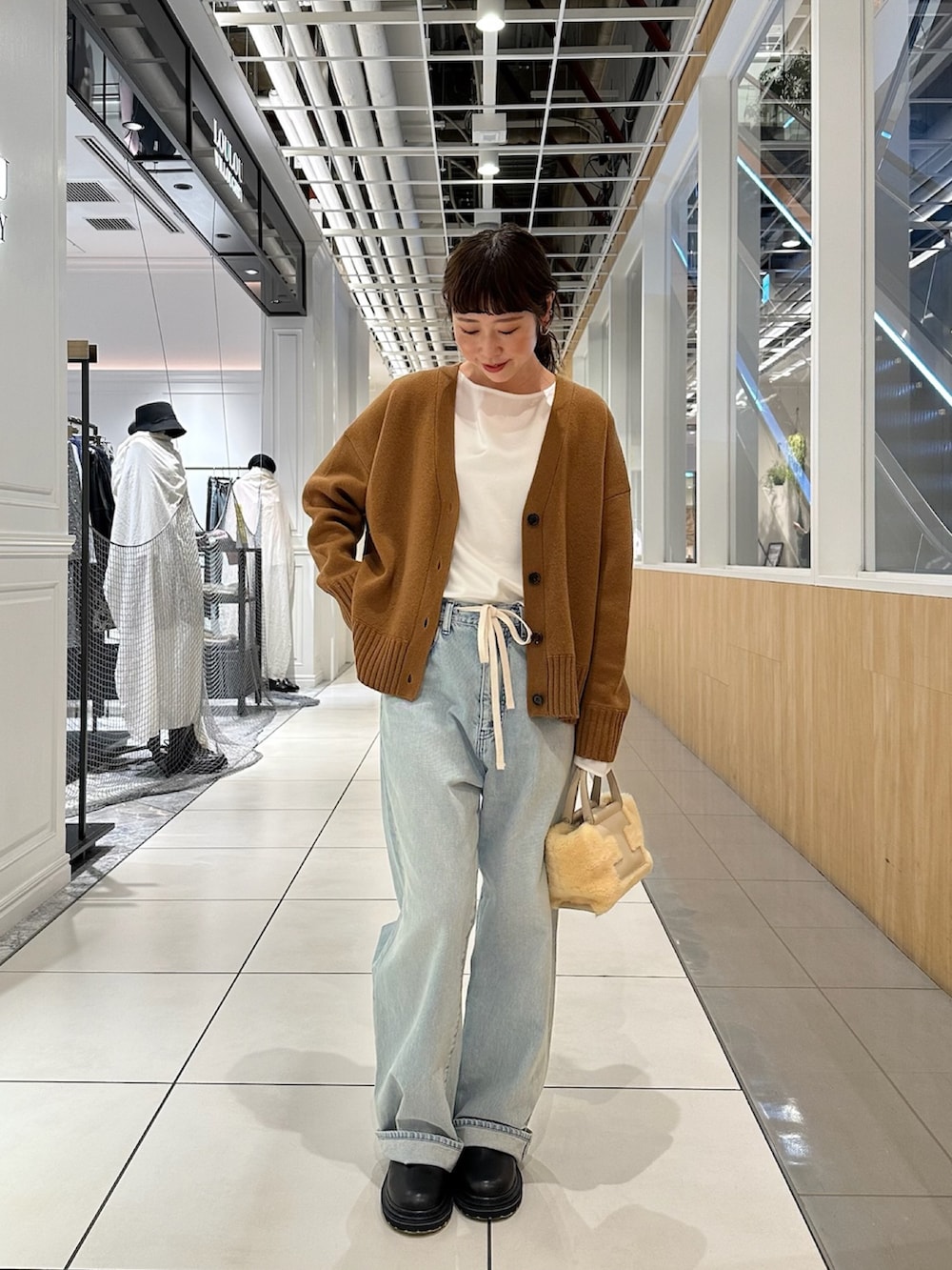 ブラウン系のカーディガン/ボレロ、ブルー系のデニムパンツを着用したレディースの秋コーディネートの3枚目の写真