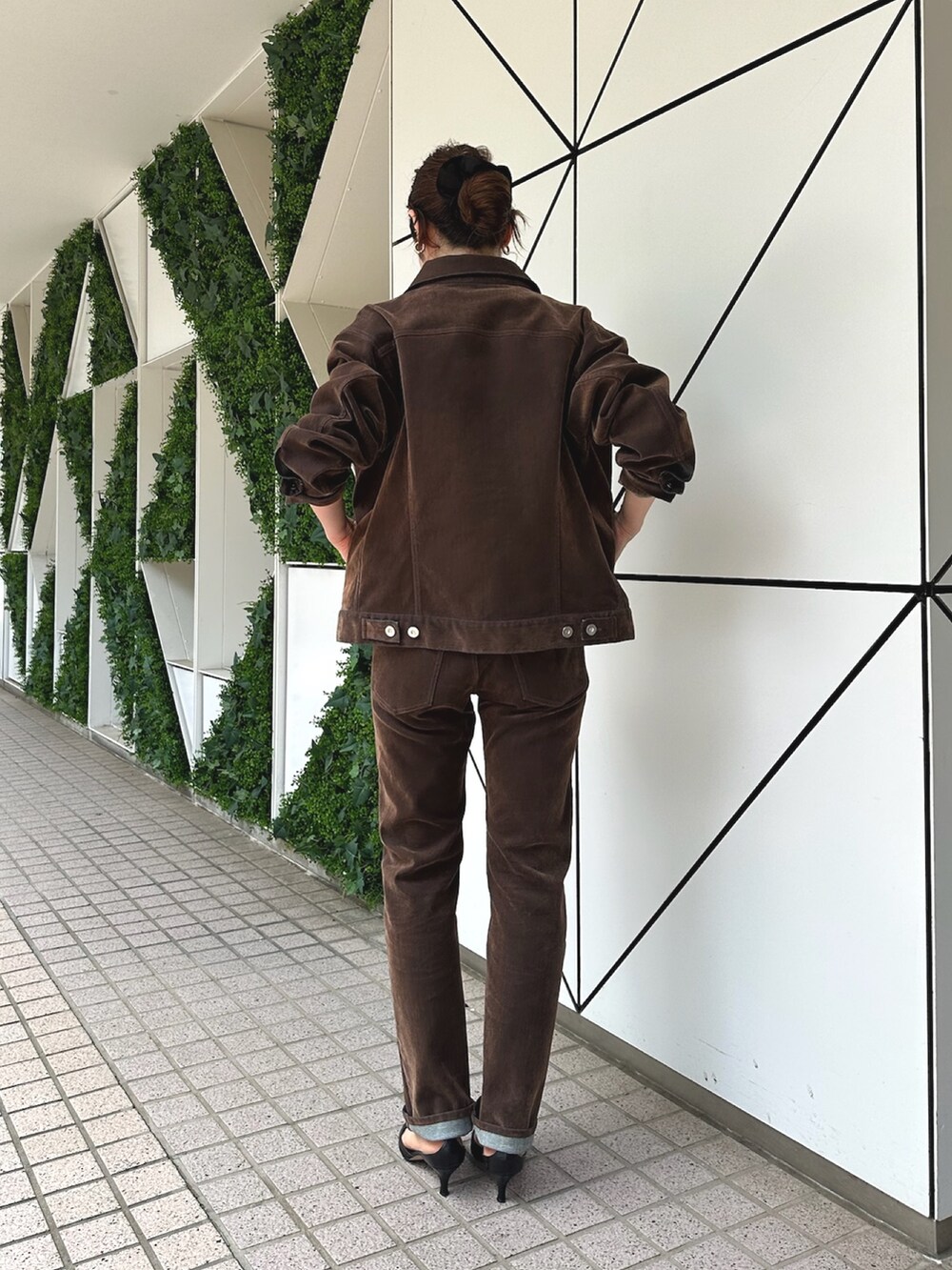 ホワイト系のショルダーバッグ、ブラック系のパンプス、ブラウン系のデニムジャケットを着用したレディースの夏コーディネートの4枚目の写真