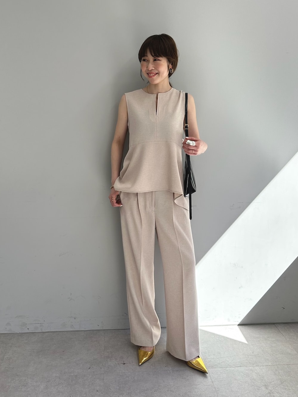 ピンク系のスラックス、ピンク系のシャツ/ブラウス、ブラウン系のショルダーバッグを着用したレディースの春コーディネートの6枚目の写真
