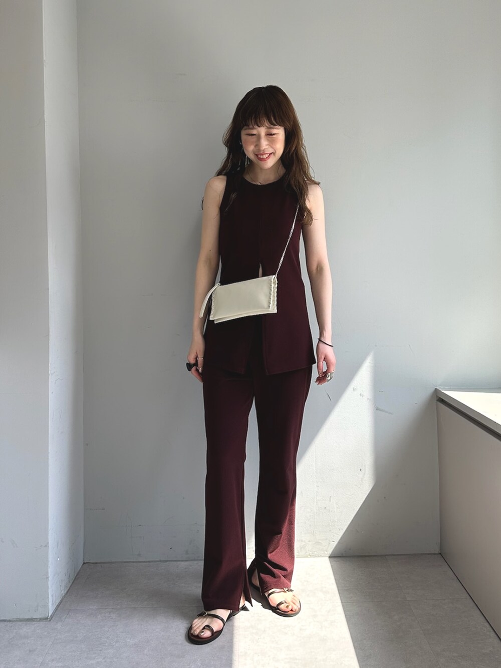 ブラック系のショルダーバッグ、レッド系の水着、レッド系の水着を着用したレディースの春コーディネートの2枚目の写真