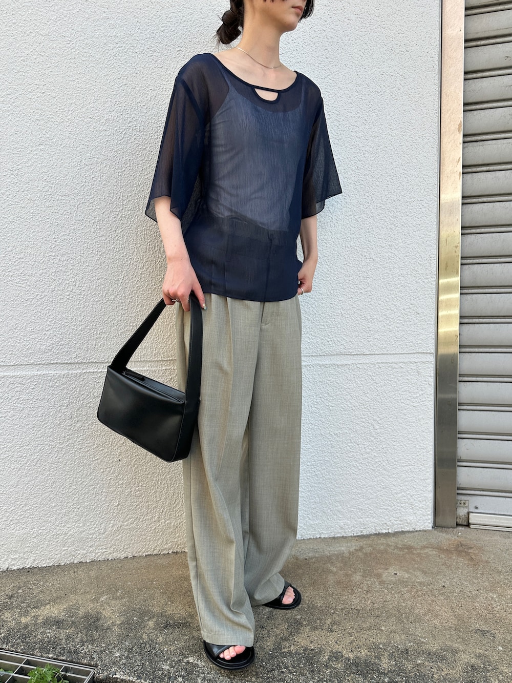 ブルー系のシャツ/ブラウス、グレー系のスラックス、ブラック系のショルダーバッグを着用したレディースの夏コーディネートの3枚目の写真