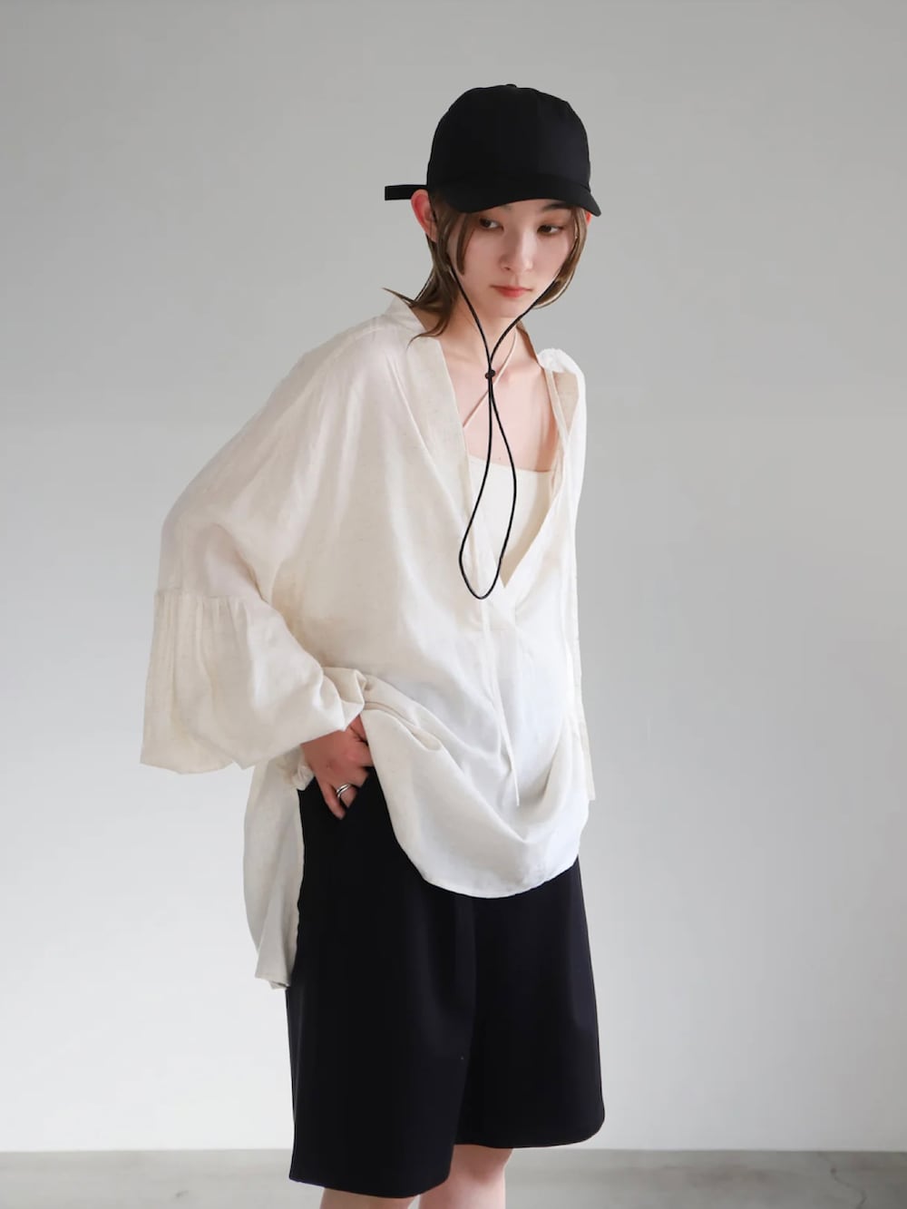 ベージュ系のシャツ/ブラウス、ブラック系のその他パンツ、ホワイト系のキャミソールを着用したレディースの春コーディネートの5枚目の写真