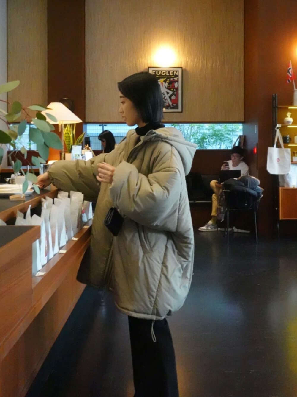 グリーン系のダウンジャケット/コート、ブラック系のその他パンツを着用したレディースの冬コーディネートの3枚目の写真