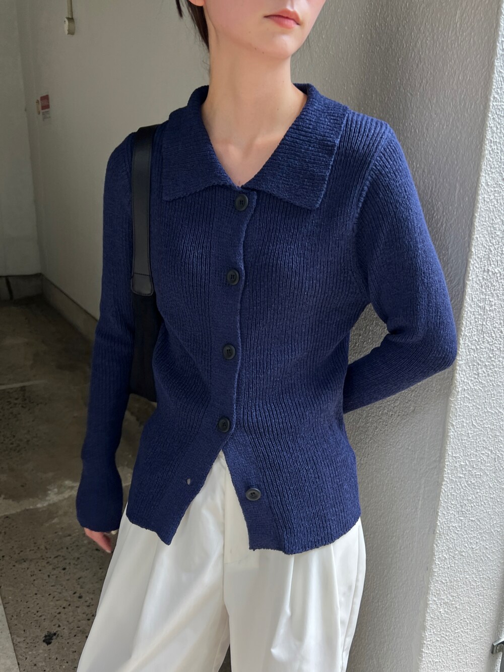 ブルー系のカーディガン/ボレロ、ホワイト系のその他パンツ、ブラック系のスリッポンを着用したレディースの秋コーディネートの4枚目の写真