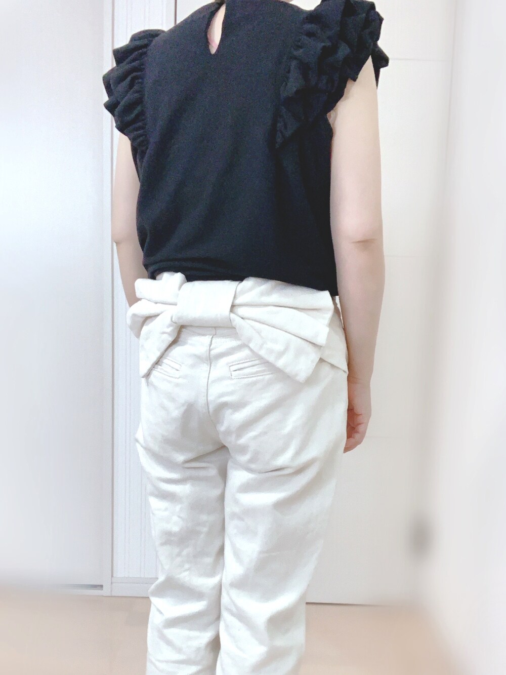 ホワイト系のデニムパンツ、ブラック系のシャツ/ブラウス、その他のスニーカーを着用したレディースの夏コーディネートの2枚目の写真