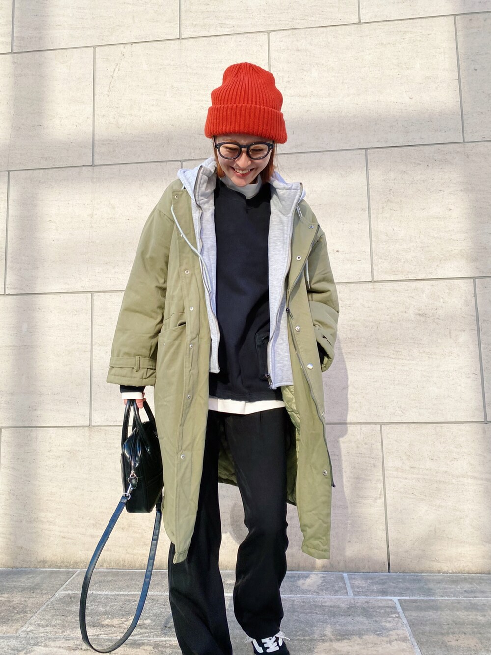 ブラック系のスウェット、ブラック系のパンツ、ブラック系のスニーカーを着用したレディースの冬コーディネートの3枚目の写真