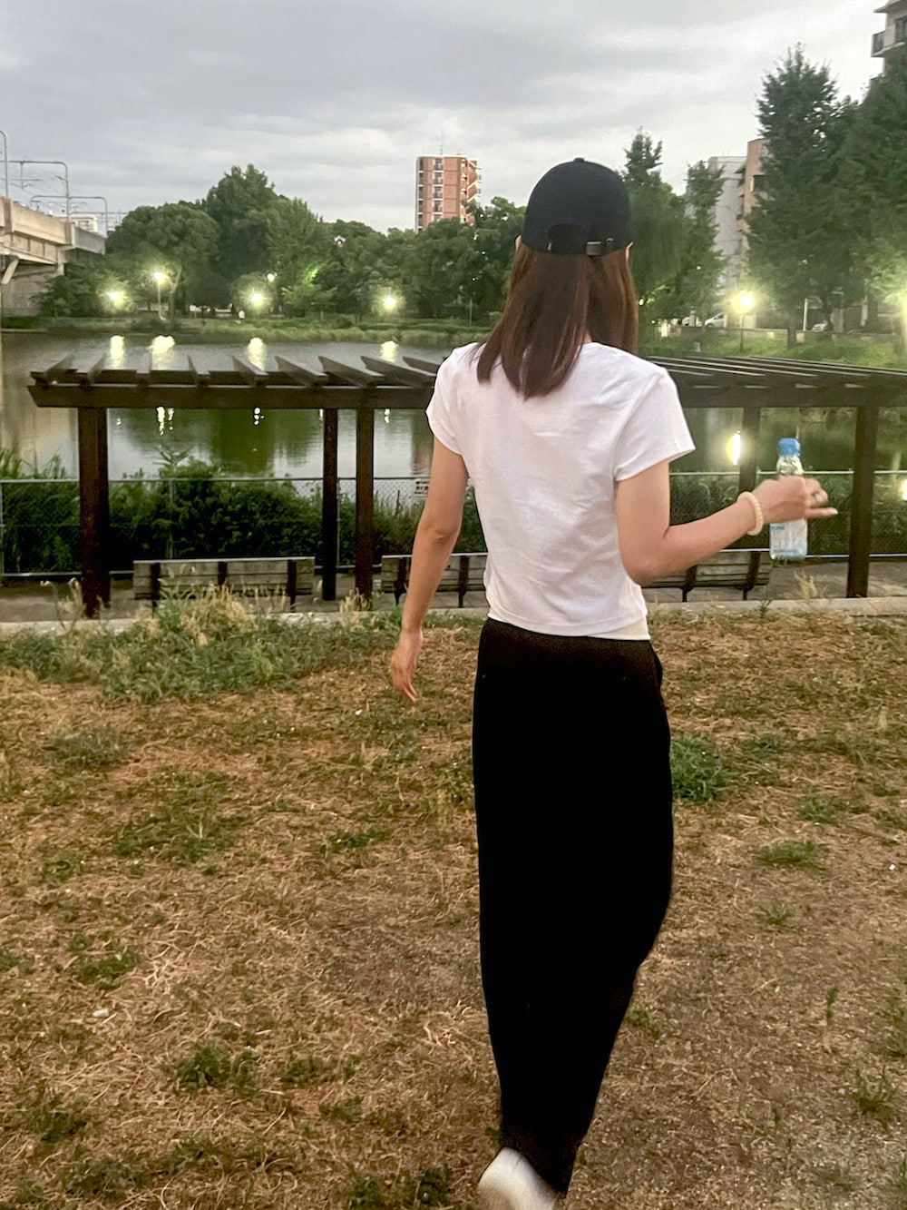 ホワイト系のTシャツ/カットソー、ブラック系のその他パンツ、ホワイト系のスニーカーを着用したレディースの夏コーディネートの2枚目の写真