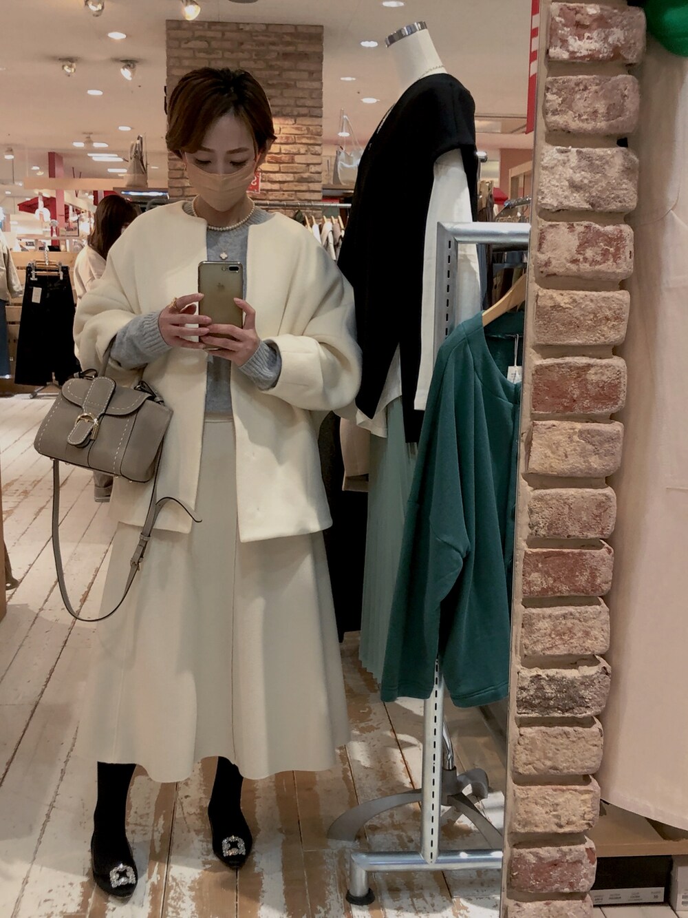 ホワイト系のスカートを着用したレディースの冬コーディネートの2枚目の写真