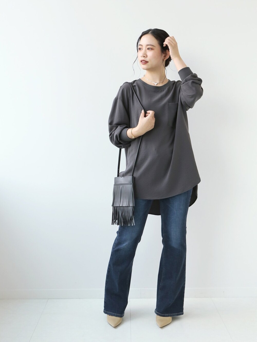 ブルー系のデニムパンツ、ブラック系のシャツ/ブラウスを着用したレディースの秋コーディネートの2枚目の写真