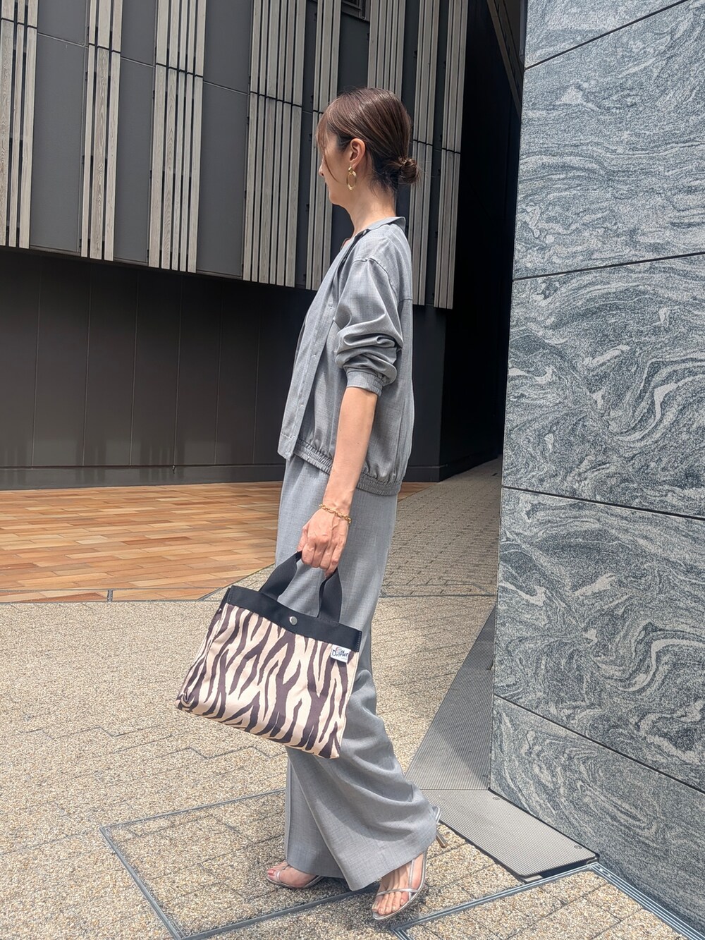 グレー系のその他パンツ、ブラック系のトートバッグを着用したレディースの夏コーディネートの2枚目の写真
