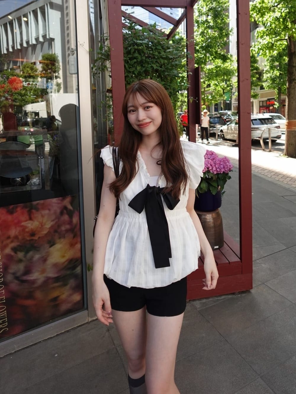 ホワイト系のシャツ/ブラウスを着用したレディースの夏コーディネートの3枚目の写真