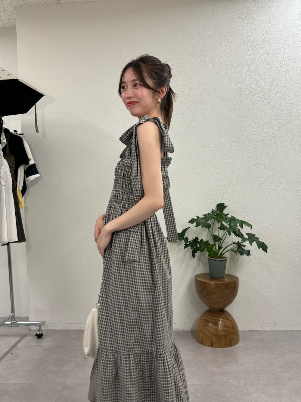 ブラック系のワンピース、ホワイト系のショルダーバッグ、ブラック系のサンダルを着用したレディースの夏コーディネートの3枚目の写真