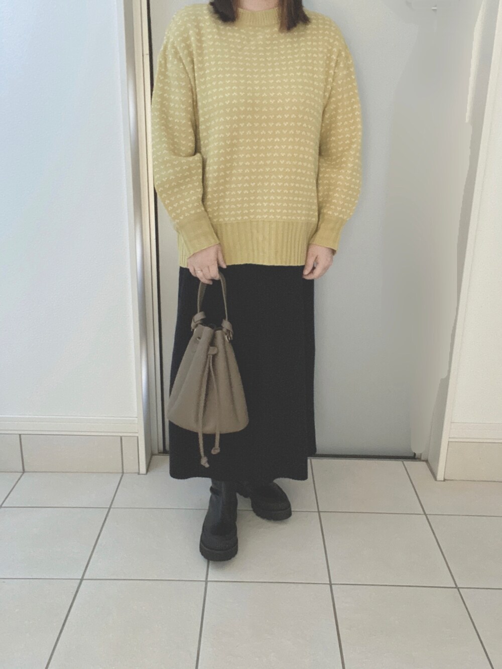 その他のショルダーバッグ、ブラック系のブーツ、ブラウン系のベストを着用したレディースの秋コーディネートの2枚目の写真