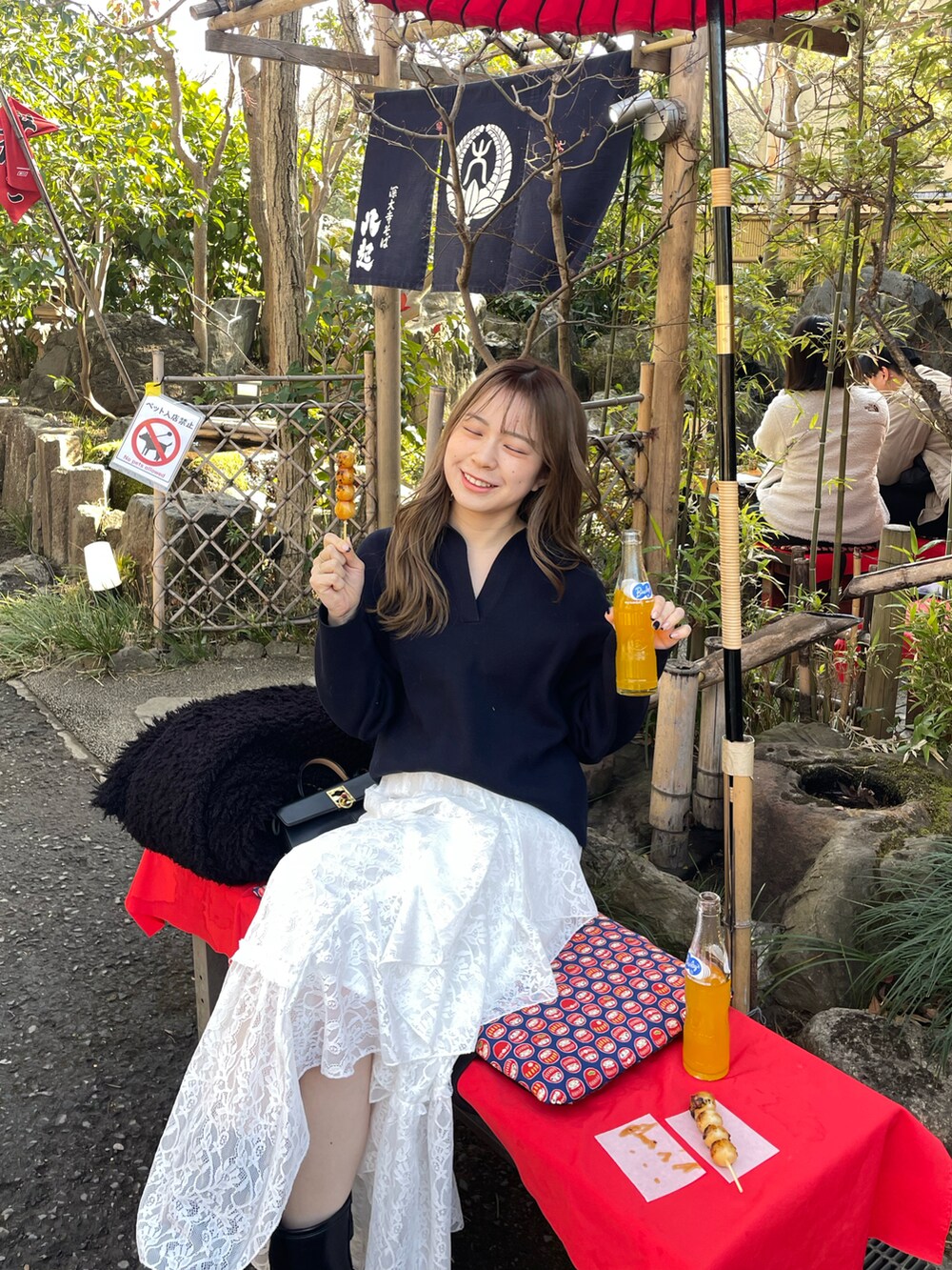 ホワイト系のスカート、ブラック系のショルダーバッグ、ブルー系のトップスを着用したレディースの冬コーディネートの2枚目の写真