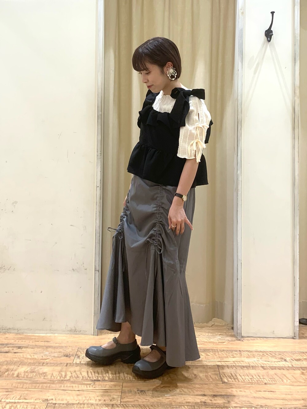 ホワイト系のTシャツ/カットソー、グレー系のスカート、ブラック系のシャツ/ブラウスを着用したレディースの夏コーディネートの2枚目の写真