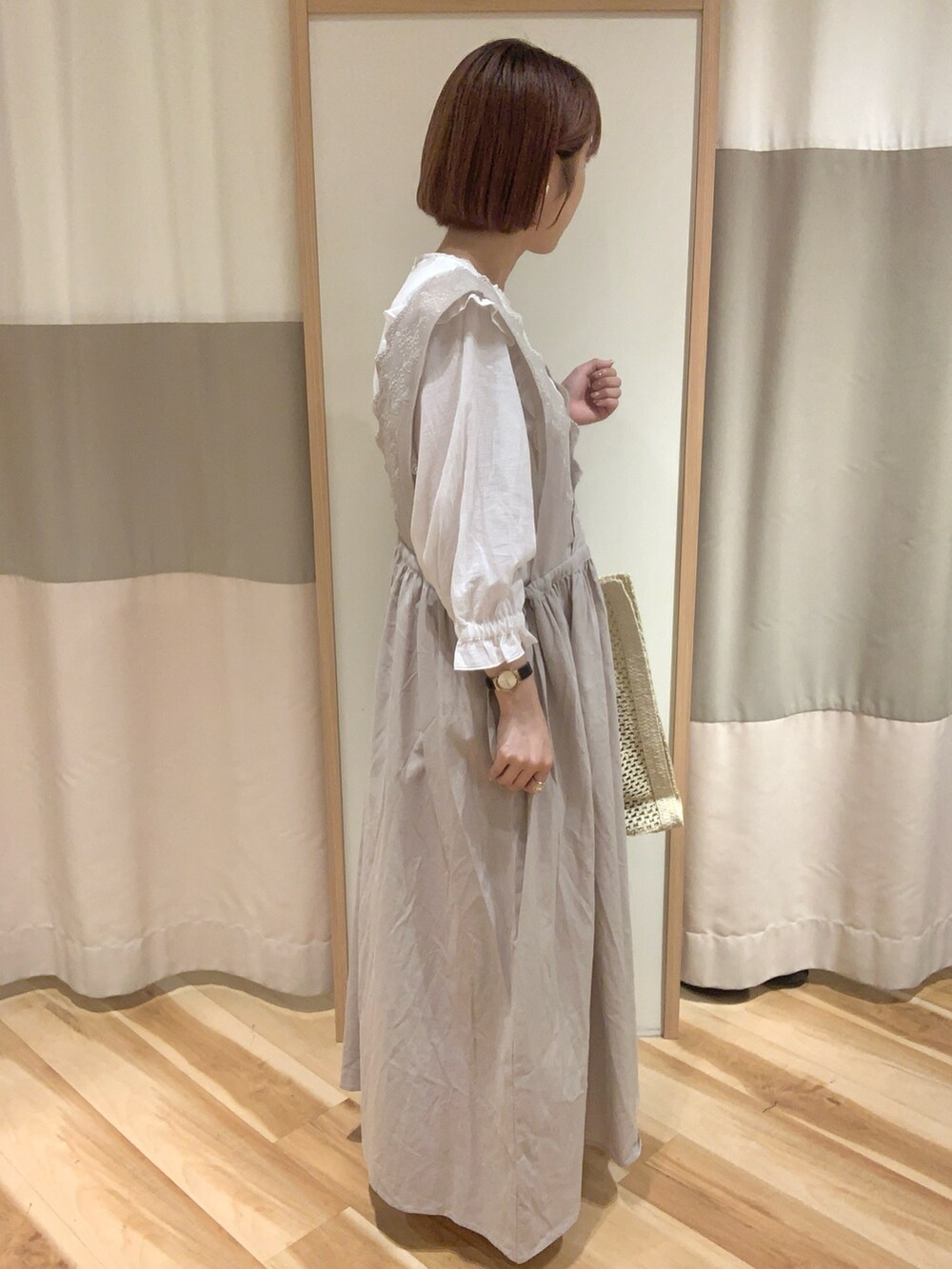 ホワイト系のワンピース、ブラック系のシャツ/ブラウス、ブラウン系のサンダルを着用したレディースの春コーディネートの2枚目の写真