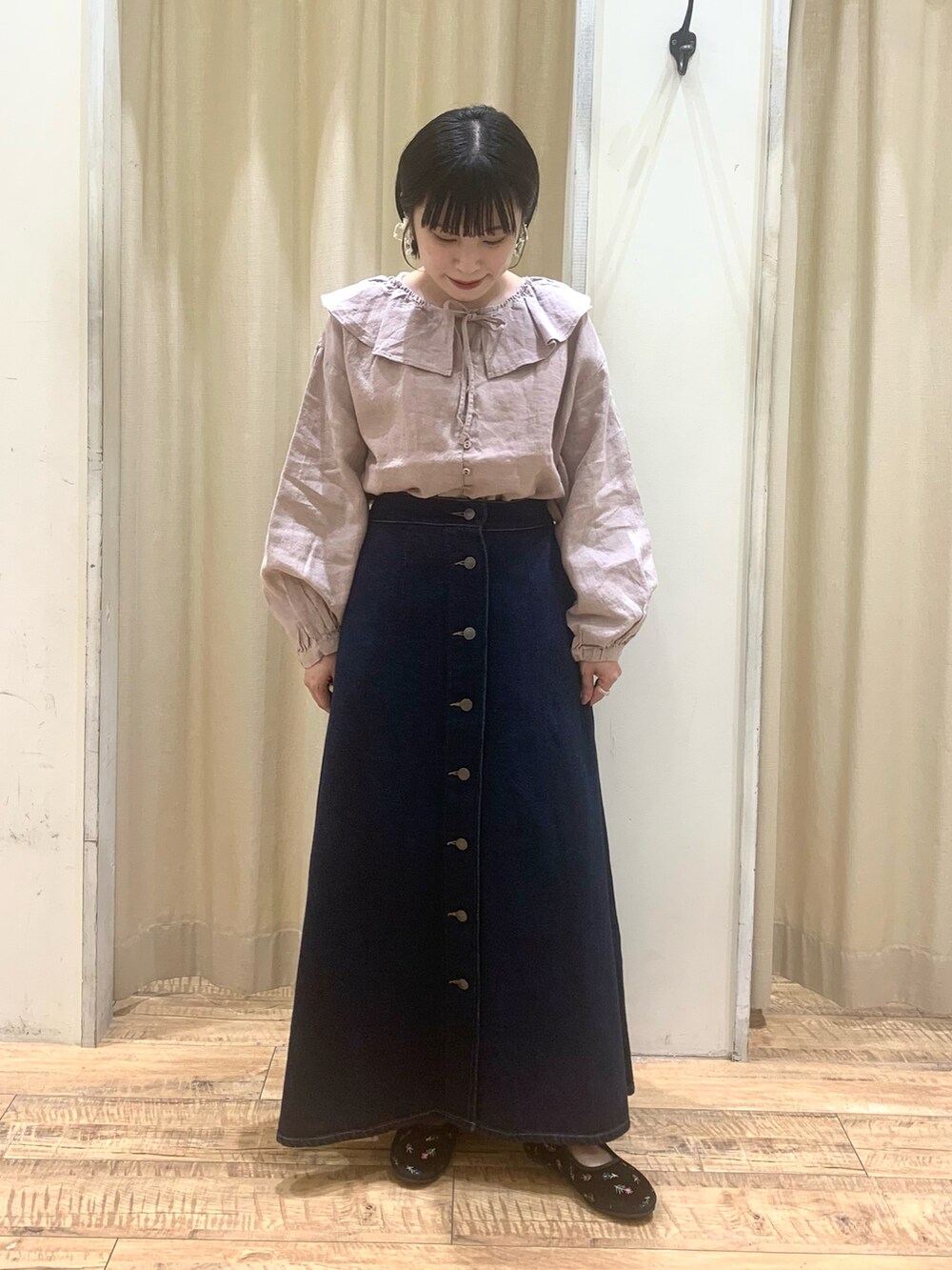 ベージュ系のシャツ/ブラウス、ブルー系のスカート、ブラック系のドレスシューズを着用したレディースの秋コーディネートの3枚目の写真