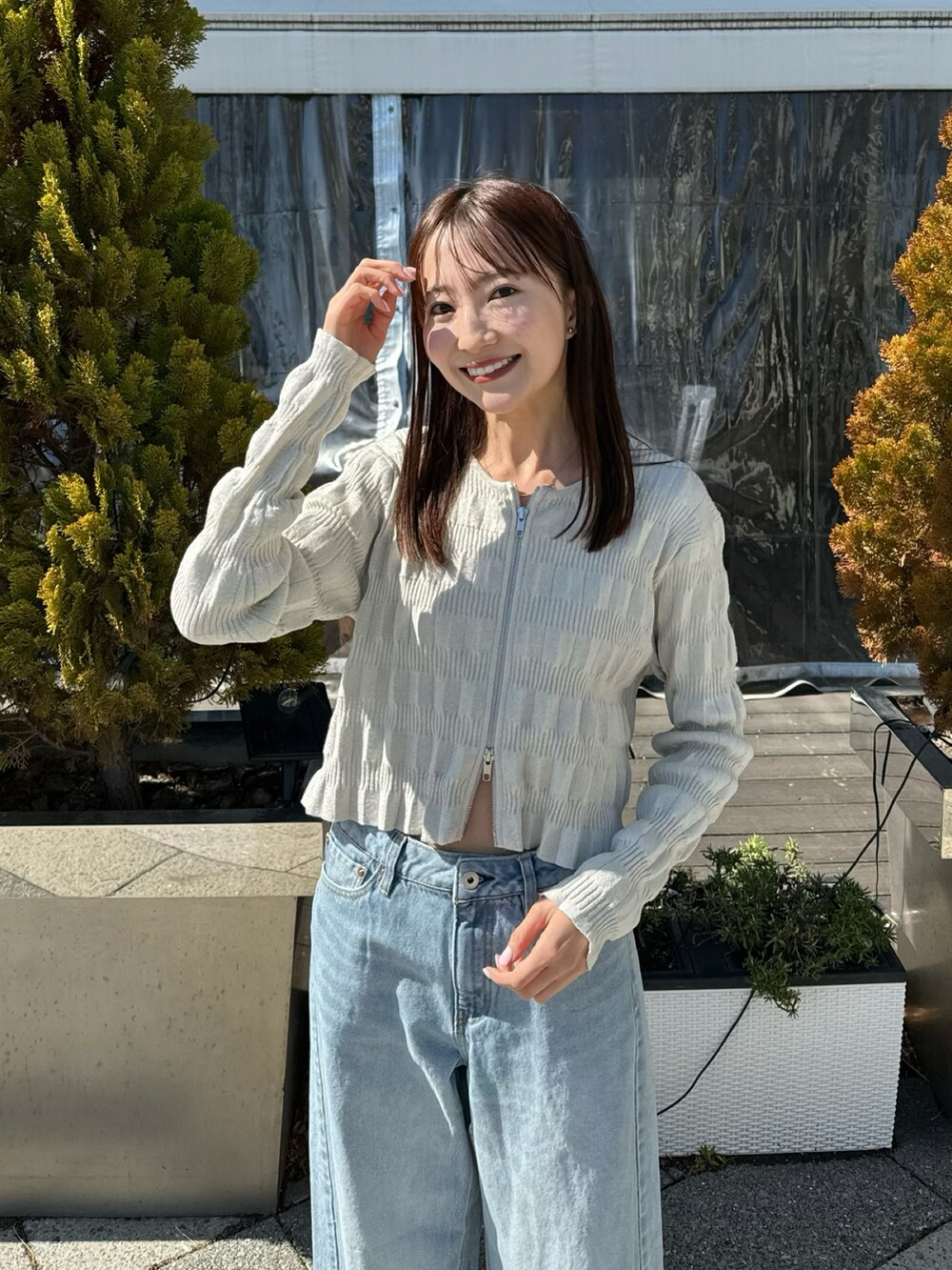 ホワイト系のカーディガン/ボレロ、ブルー系のデニムパンツ、ベージュ系のハットを着用したレディースの春コーディネートの3枚目の写真