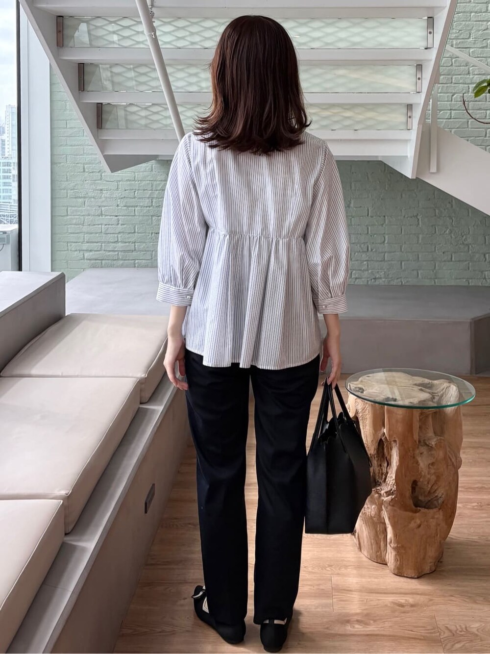 ブルー系のその他パンツ、ブラック系のトートバッグ、ブラック系のパンプスを着用したレディースの春コーディネートの5枚目の写真