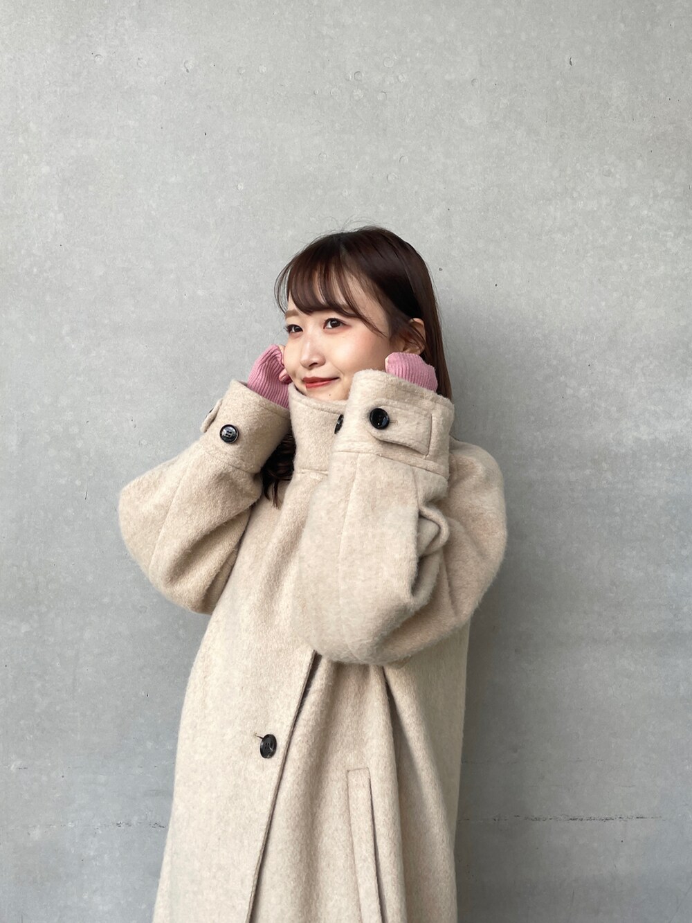 ベージュ系のその他アウター、ピンク系のニット/セーターを着用したレディースの冬コーディネートの2枚目の写真