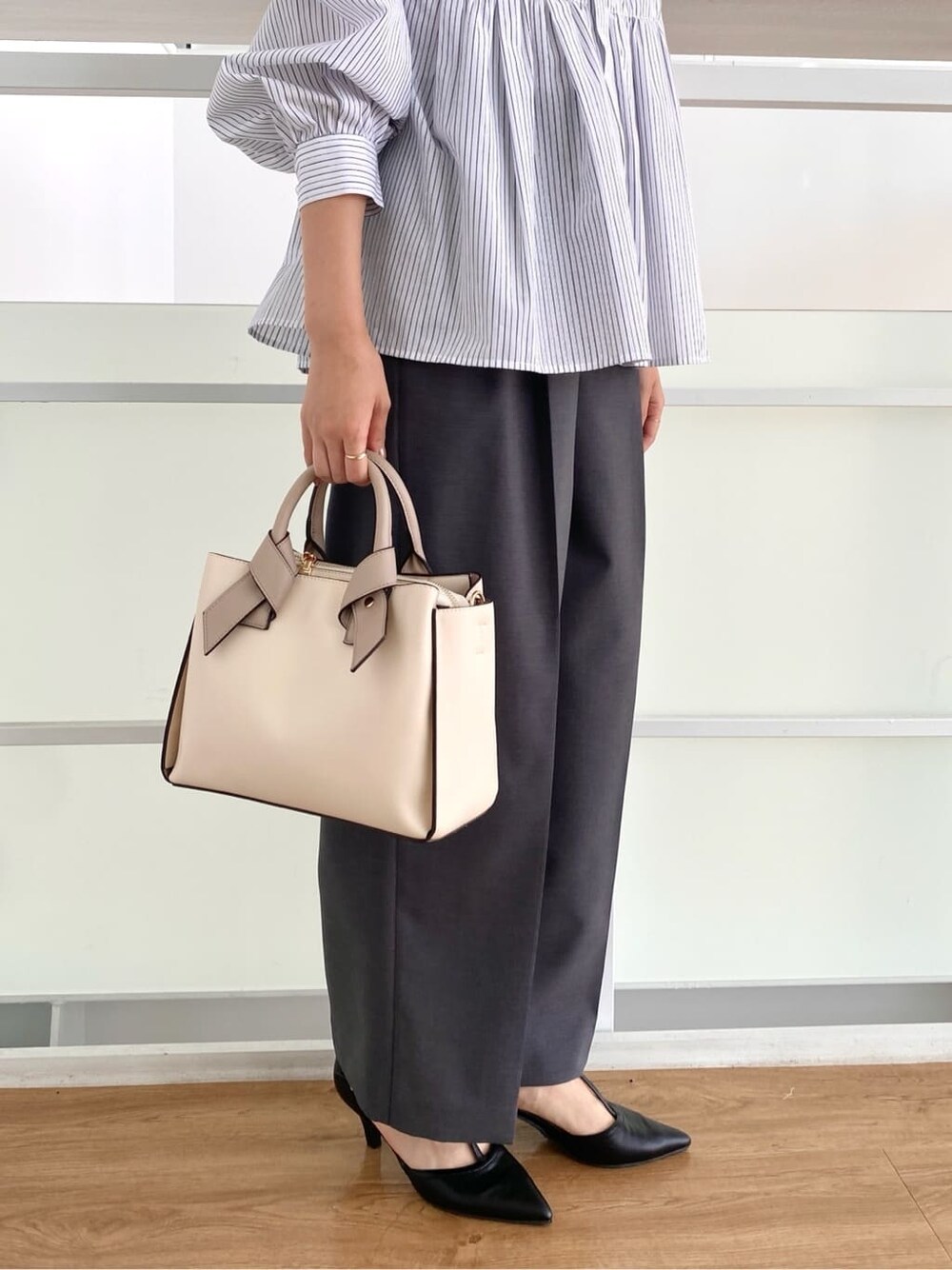 ホワイト系のシャツ/ブラウス、グレー系のその他パンツ、ホワイト系のトートバッグを着用したレディースの秋コーディネートの10枚目の写真