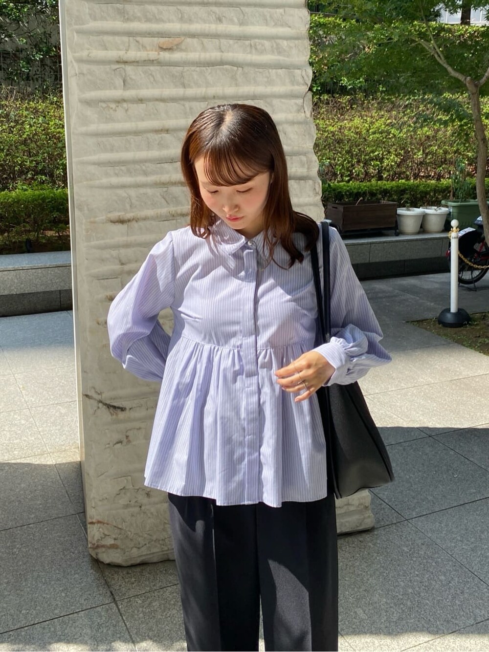 ブルー系のシャツ/ブラウス、ブラック系のその他パンツ、ブラック系のトートバッグを着用したレディースの秋コーディネートの6枚目の写真
