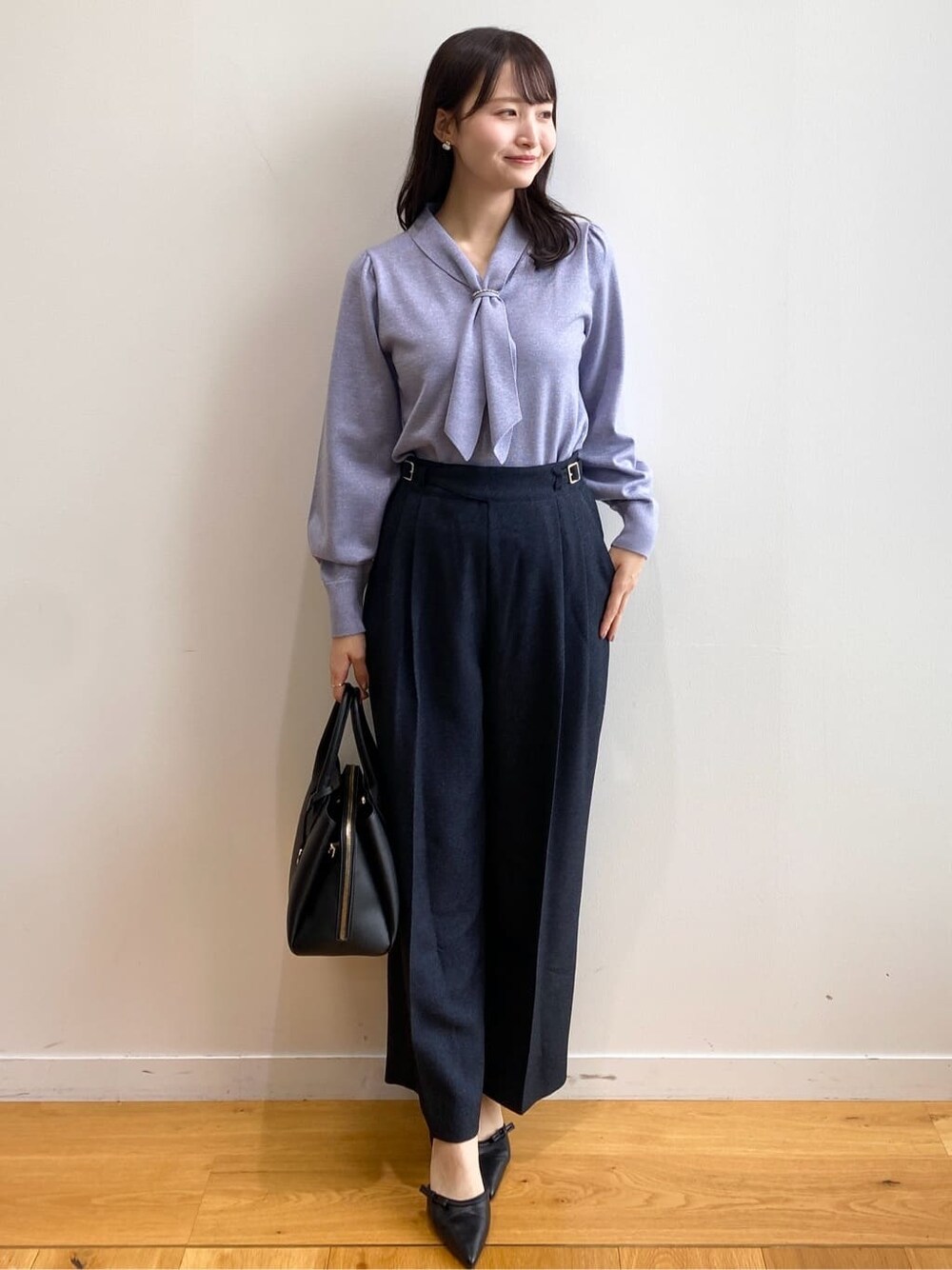 ブルー系のニット/セーター、ブルー系のその他パンツ、ブラック系のボストンバッグを着用したレディースの秋コーディネートの2枚目の写真