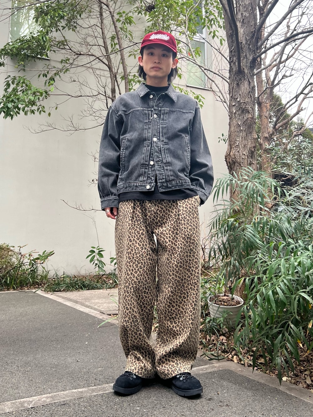 グリーン系のミリタリージャケット、ブラック系のデニムジャケット、イエロー系のチノパンツを着用したメンズの春コーディネートの2枚目の写真