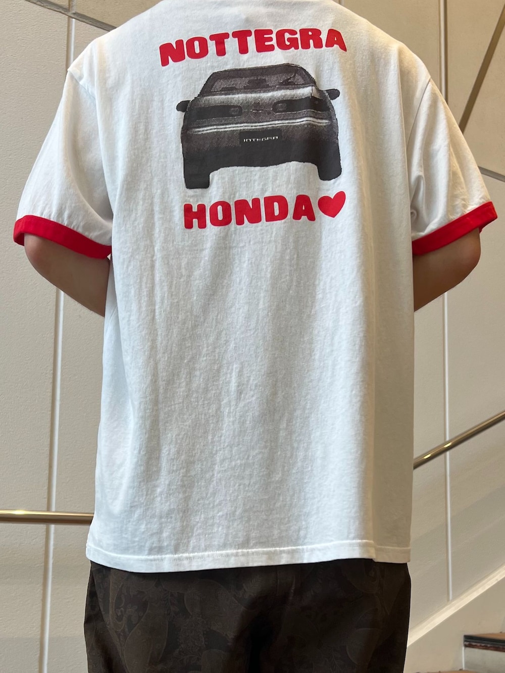 ブラウン系のスラックス、グリーン系のシャツ/ブラウス、ホワイト系のTシャツ/カットソーを着用したメンズの夏コーディネートの5枚目の写真